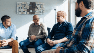 One man speaking during a group discussion while others listen in a circle