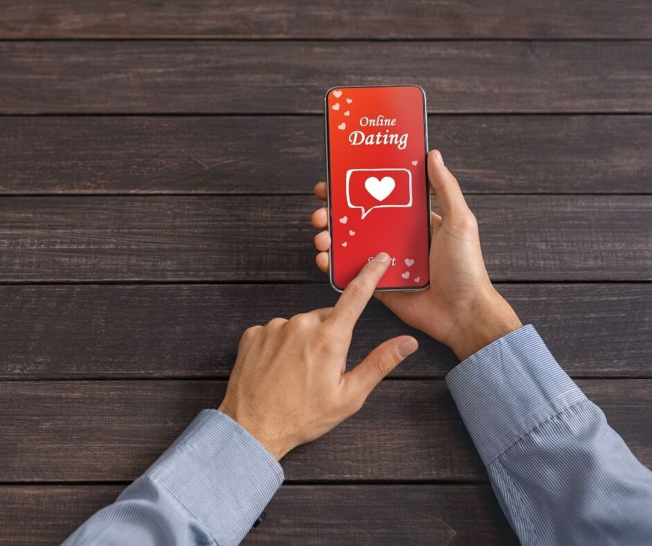 A phone is displayed against a dark wooden table with an image that reads 