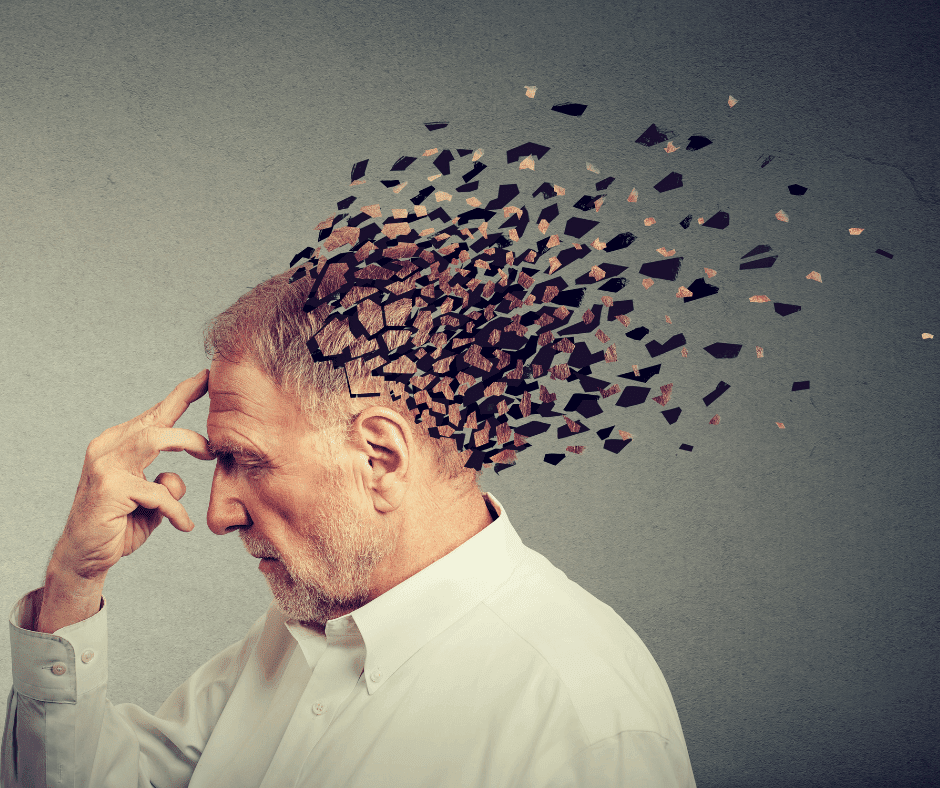 A man has his fingers on his forehead as his head begins to float away in several different pieces, like a puzzle.