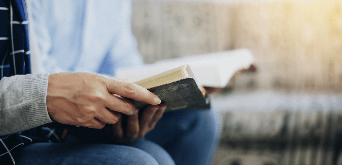 Focus shot on couple sitting reading book for recovery on a corner