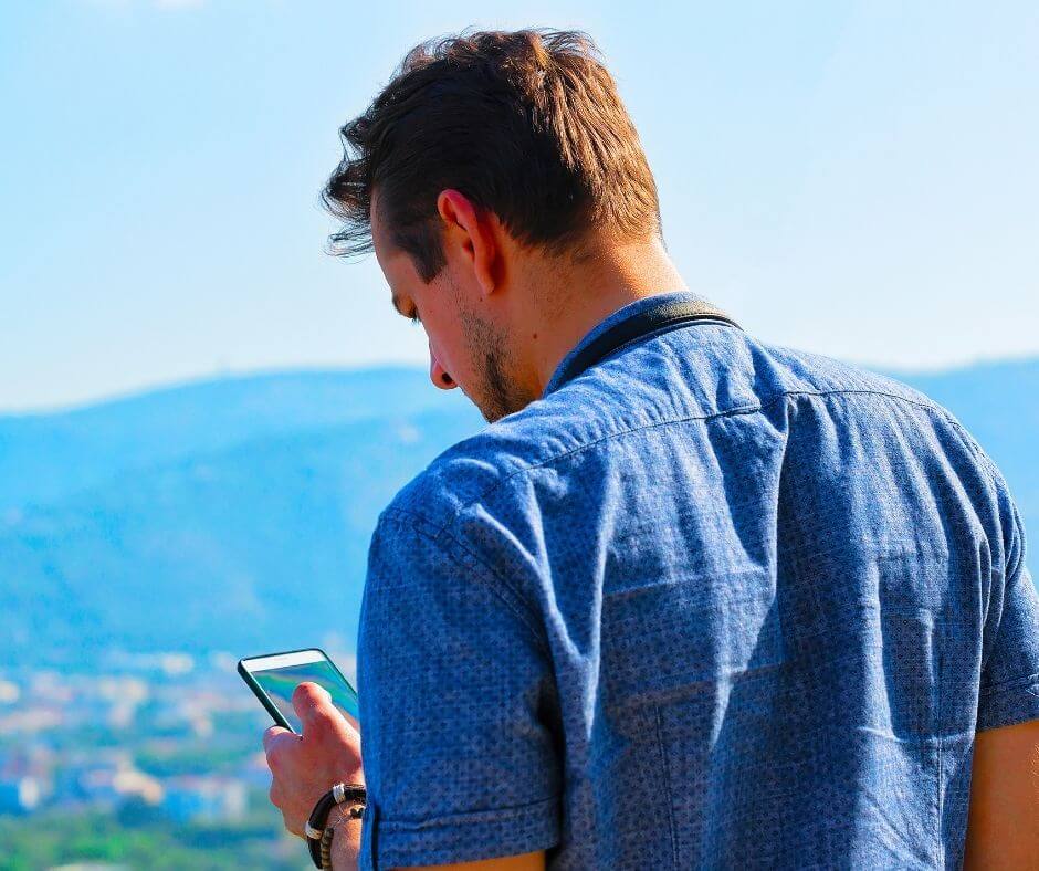 A man looking stressed as he looks at his phone