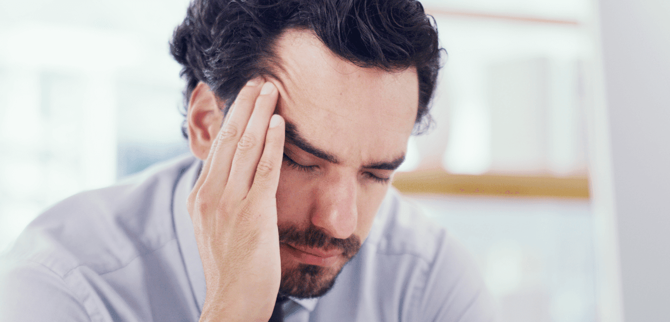 Man sitting alone going through hard time, holding his head