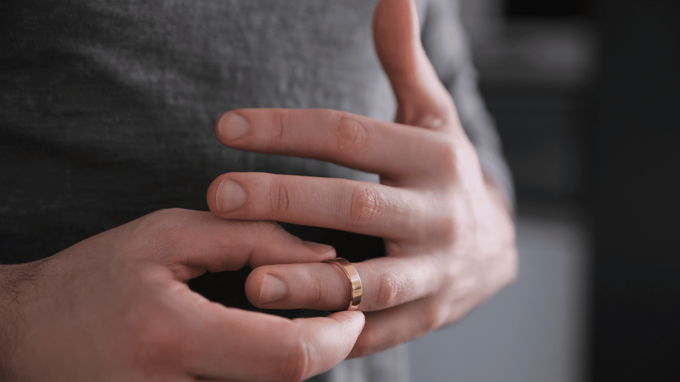 Close-up of a man's hand removing a wedding ring