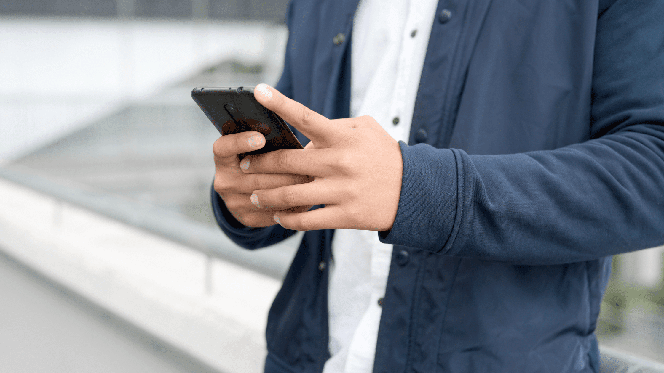 Man chatting online on his phone, shown in a close-up shot