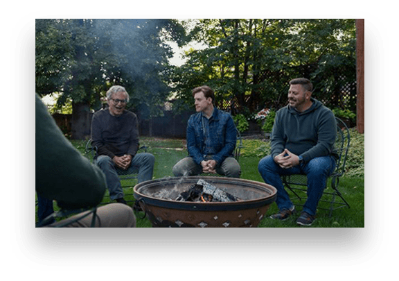 men sitting around a fire