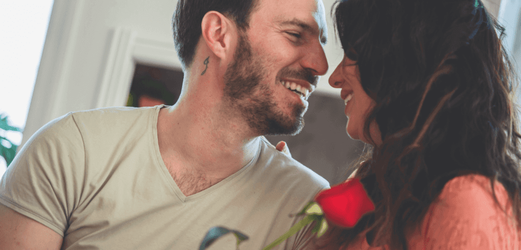 Moment of affection between husband and wife. They are face to face and smiling while embracing one another.