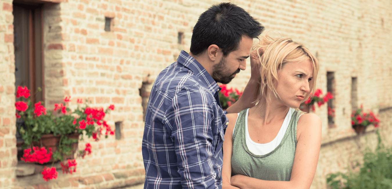 Man trying to have a conversation with his girlfriend, while his girlfriend looking away ignoring her